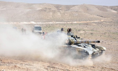 Forces loyal to Syria's President Bashar al-Assad drive a tank during their offensive to recapture the historic city of Palmyra in this picture provided by SANA on March 24, 2016. REUTERS/SANA/Handout via Reuters ATTENTION EDITORS - THIS PICTURE WAS PROVIDED BY A THIRD PARTY. REUTERS IS UNABLE TO INDEPENDENTLY VERIFY THE AUTHENTICITY, CONTENT, LOCATION OR DATE OF THIS IMAGE. FOR EDITORIAL USE ONLY. NOT FOR SALE FOR MARKETING OR ADVERTISING CAMPAIGNS. THIS PICTURE IS DISTRIBUTED EXACTLY AS RECEIVED BY REUTERS, AS A SERVICE TO CLIENTS